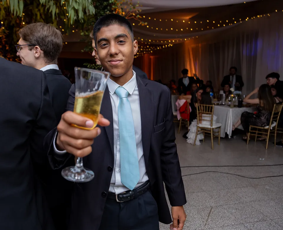 Joaquín Caballero raising a toast at a year-end party