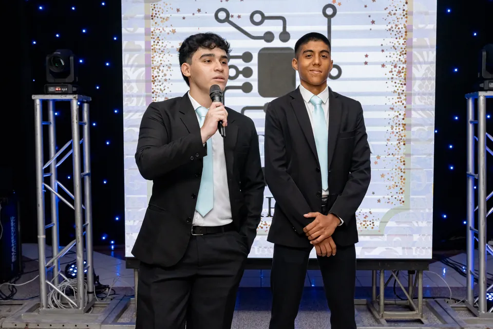 Joaquín Caballero, on the right, on stage at a year-end party