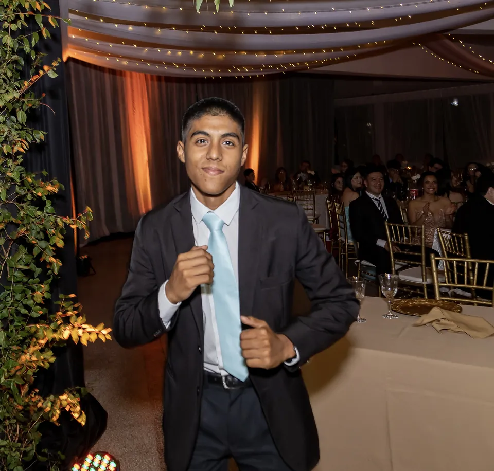 Joaquín Caballero in a suit at a year-end party