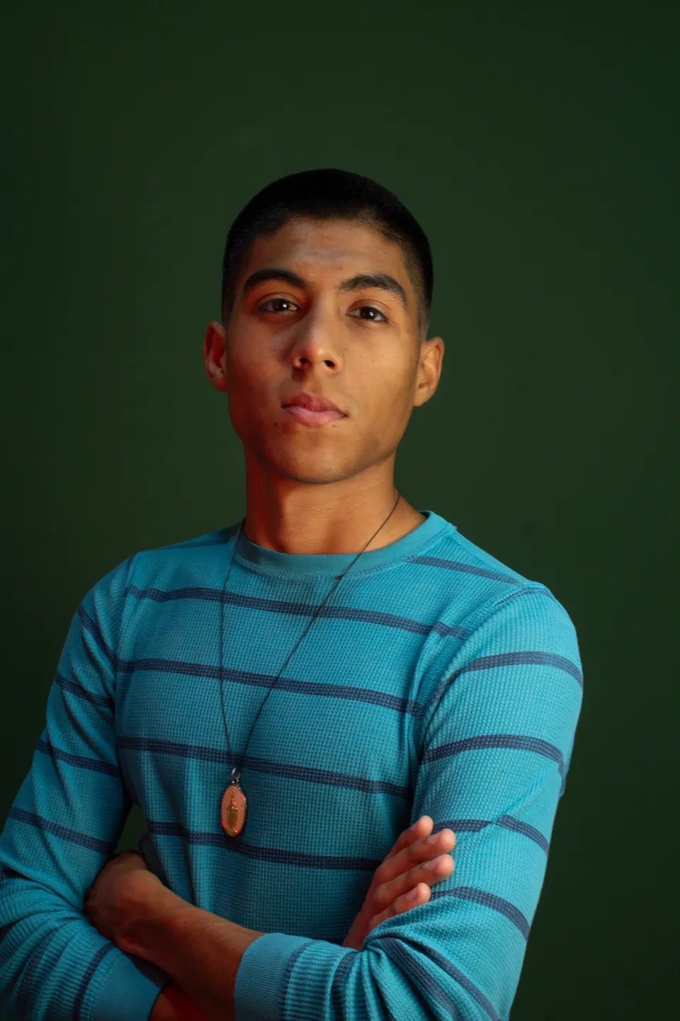 Joaquín Caballero, the hardest working man in Paraguay, studio portrait in a striped sweater